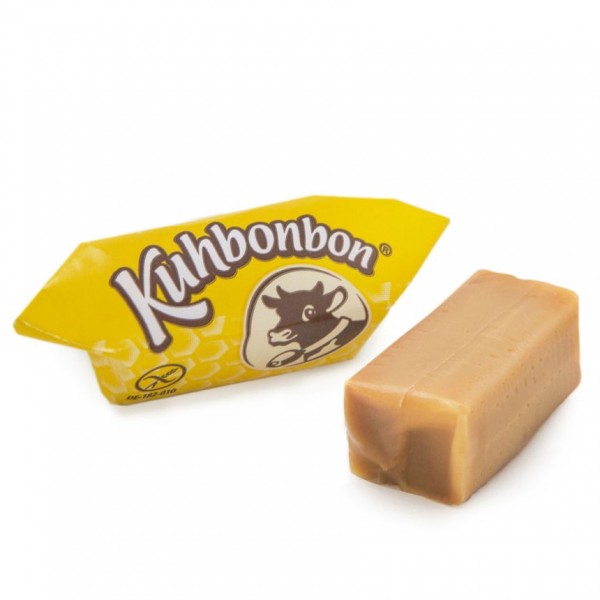 Two pieces of soft caramels with milk & honey flavor from the German candy manufacturer Kuhbonbon, one individually wrapped